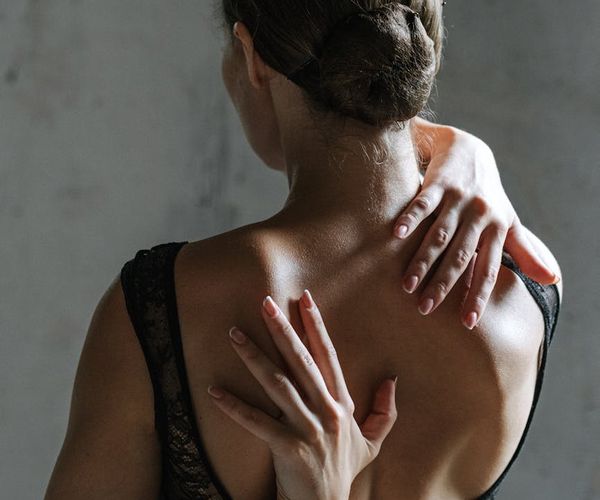 A person stretching gracefully, highlighting the concept of flexibility.